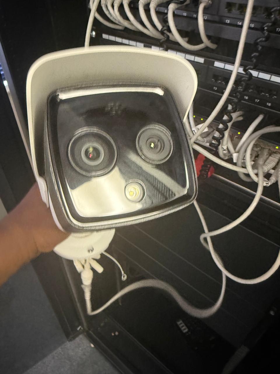 Security camera being installed alongside network infrastructure